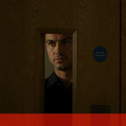 Cristiano Ronaldo observa pela porta antes da conferência de imprensa