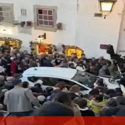 Carro tenta atravessar multidão no Castelo de Óbidos durante Vila de Natal