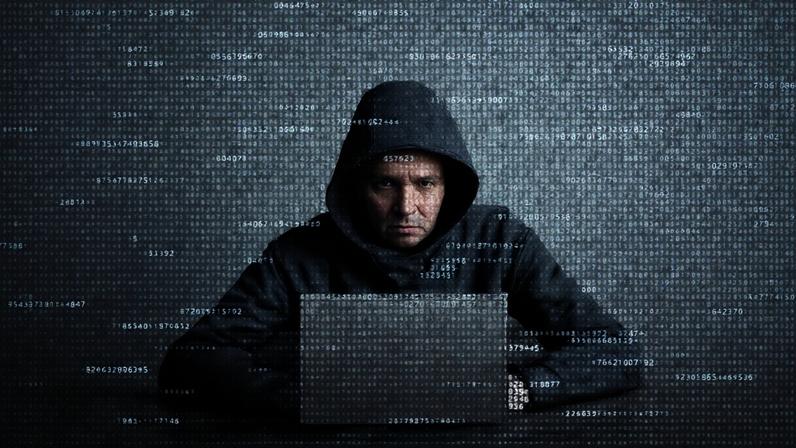 Hacker in data security concept. Hacker using laptop. Hacking the Internet. Cyber attack.