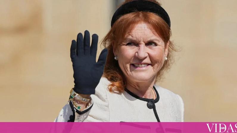 Sarah Ferguson sorri e acena com uma luva preta