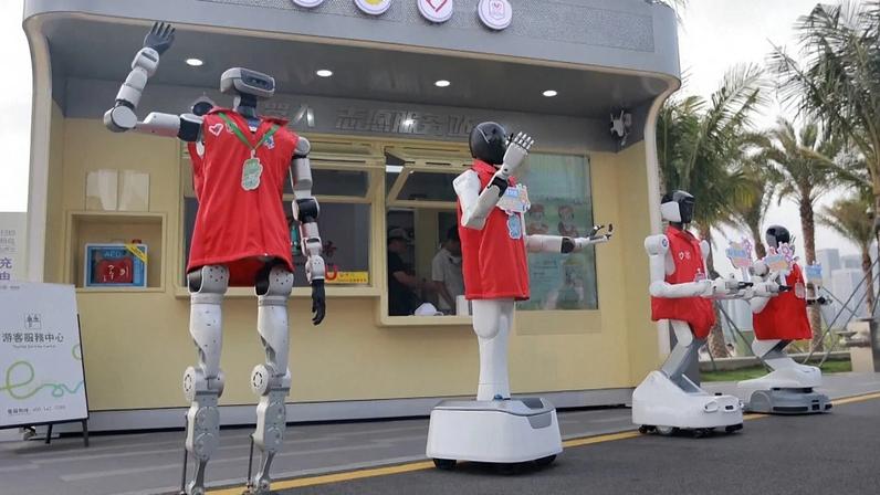 Robôs voluntários em frente à estação de serviço de voluntários robóticos no Parque Qianhaishi, na China