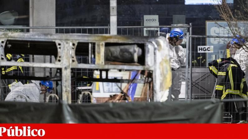 Investigadores examinam os destroços carbonizados de um autocarro após um incêndio em Kerzers, Suíça