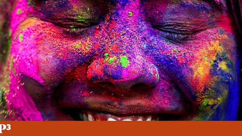 Uma participante com o rosto manchado de pó colorido participa nas celebrações do Holi, em Mumbai, Índia