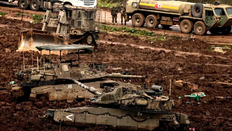 Israeli army Merkava main battle tanks are positioned in the upper Galilee in northern Israel near the border with southern Lebanon on March 26, 2026. Lebanon was drawn into the Middle East war on March 2, when pro-Iran Hezbollah launched rockets towards Israel in response to US-Israeli strikes that killed Iranian supreme leader on February 28. (Photo by Jack GUEZ / AFP) /