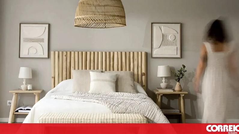 Quarto com cama de madeira e tecidos naturais, para um ambiente confortável e acolhedor