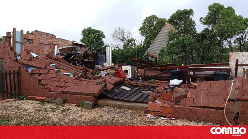 Casa destruída após forte tempestade, com escombros e objetos espalhados
