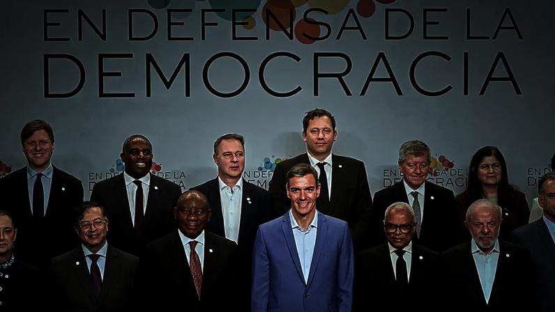 Presidente do Governo espanhol, Pedro Sánchez, de fato claro, posa com participantes da Cimeira pela Defesa da Democracia, realizada em Barcelona, a 18 de abril.