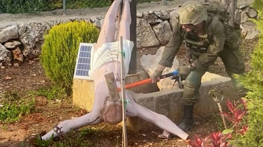 Um soldado das FDI esmaga o rosto de uma estátua de Jesus no sul do Líbano