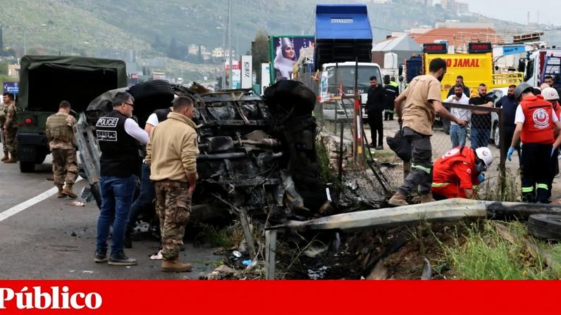 Socorristas e soldados libaneses junto aos destroços de um carro atingido por drones israelitas numa auto-estrada a sul de Beirute, esta quarta-feira