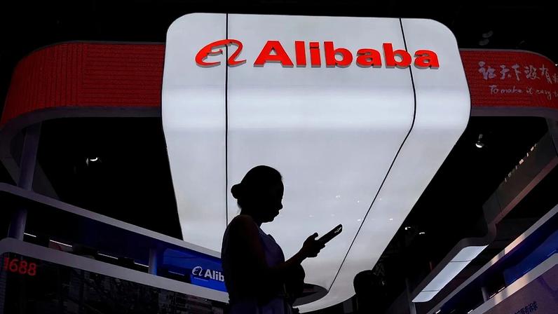 ARQUIVO - Um visitante passa em frente do stand da Alibaba durante a 3.ª Exposição Internacional da Cadeia de Abastecimento, em Pequim, 18 de julho de 2025
