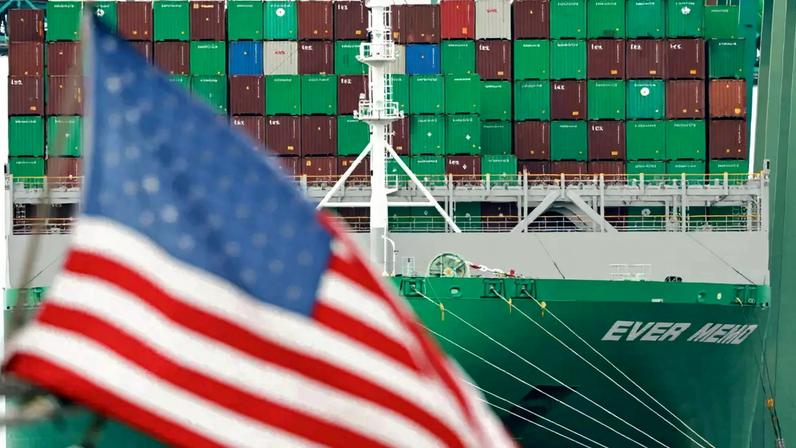 LOS ANGELES, CALIFORNIA - MAY 28: An American flag flies near the Ever Memo container ship at the Port of Los Angeles on May 28, 2026 in Los Angeles, California. The Trump administration has refunded more than $20 billion in tariffs to importers and shippers so far, according to a court filing, with as much as $65 billion still expected to be paid in the wake of a Supreme Court ruling over the administration"s sweeping tariffs. Mario Tama/Getty Images/AFP